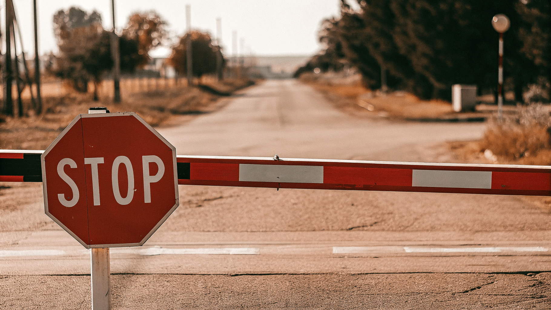 a road closed with a stop sign illustrating identify the roadblocks