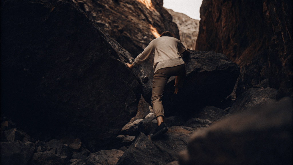 Exploring your inner compass 7 someone climbing over boulders on a. mountain pass. identifying the route to making a change